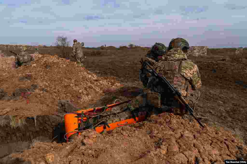 Combat medics train in new tactics for evacuating injured soldiers on the battlefield, in Khurakhove, March 1, 2024. In the last few months, kamikaze drones have been targeting evacuations of injured soldiers more frequently. 