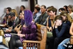 Plaintiffs listen to testimony during a hearing in the climate change lawsuit, Held vs. Montana, at the Lewis and Clark County Courthouse, June 13, 2023, in Helena, Mont.