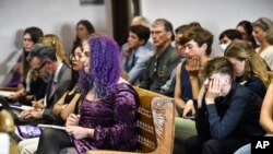 Plaintiffs listen to testimony during a hearing in the climate change lawsuit, Held vs. Montana, at the Lewis and Clark County Courthouse, June 13, 2023, in Helena, Mont.