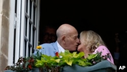U.S. WWII veteran Harold Terens, 100, left, and Jeanne Swerlin, 96, kiss in Normandy, France, June 8, 2024.