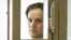 FILE - Wall Street Journal reporter Evan Gershkovich stands in a glass cage in a courtroom at the Moscow City Court in Moscow, Russia, June 22, 2023.