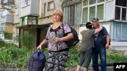 FILE — Residents evacuate from Kruglyakivka village near the Ukrainian city of Kupiansk in the Kharkiv region after Russian army shelled the area, Aug. 15, 2023.