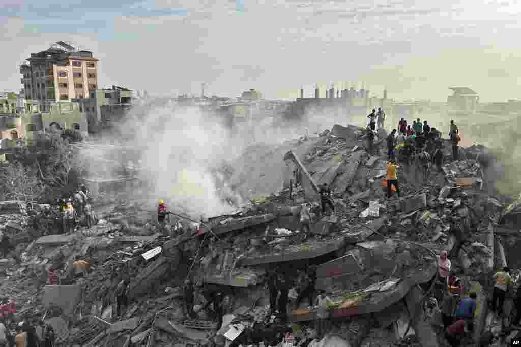 Palestinians search for survivors following Israeli airstrike in Nusseirat refugee camp, Gaza Strip.