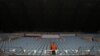 FILE - A steward stands amidst empty seats at Arena Khimki stadium in Moscow, Russia, Sept. 30, 2014. Moscow on Tuesday postponed the World Friendship Games which had been due to take place in Russia in September.