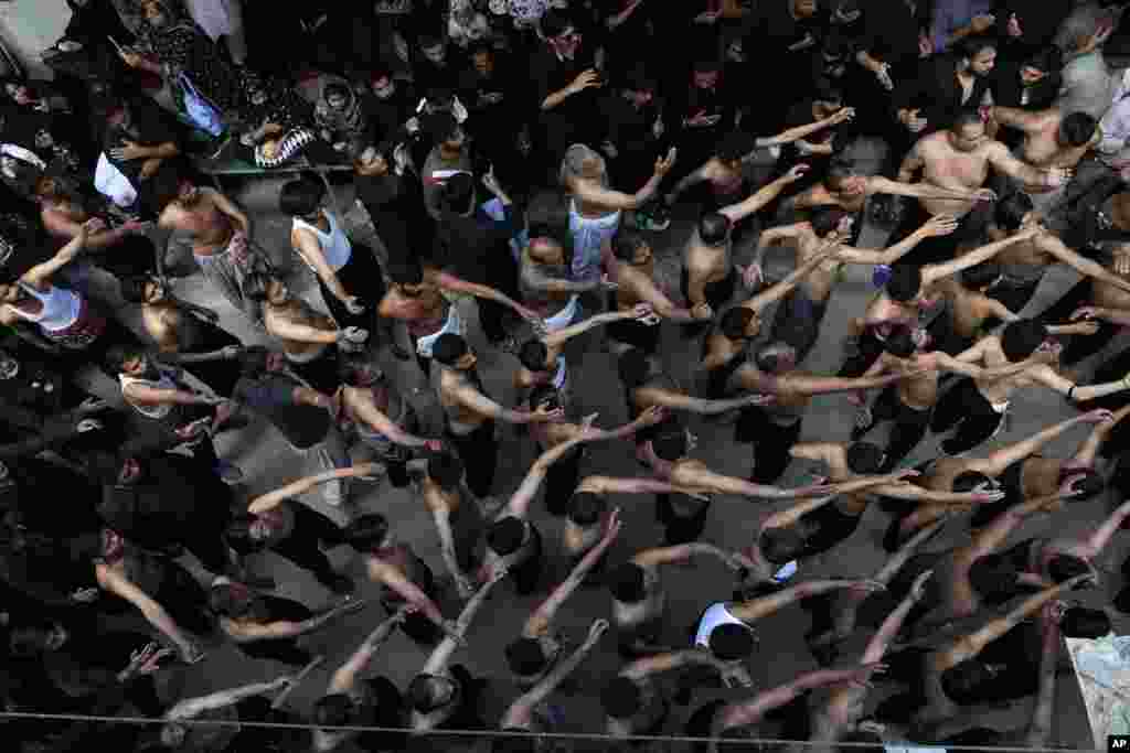 Pakistani Shiite Muslims take part in a procession commemorating the death anniversary of Imam Ali, the son-in-law and cousin of the Prophet Muhammad and the first Imam of the Muslim Shiites, in Lahore, Pakistan.