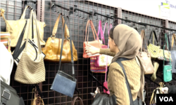 Nadia Al Arif sedang memilih tas di toko barang bekas.