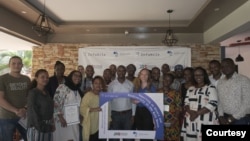 Water Journalists Africa founder Fredrick Mugira (center-left) and InfoNile co-founder Annika McGinnis (center-right) pose for a group photo at a training session with journalists from the Nile Basin. (Credit: InfoNile)