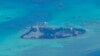 FILE - Chinese structures and buildings at the man-made island on Johnson South Reef at the Spratly Islands in the South China Sea are seen on March 20, 2022. 