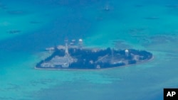 FILE - Chinese buildings and buildings on the man-made island on Johnson South Reef on the Spratly Islands within the South China Sea are seen on March 20, 2022.