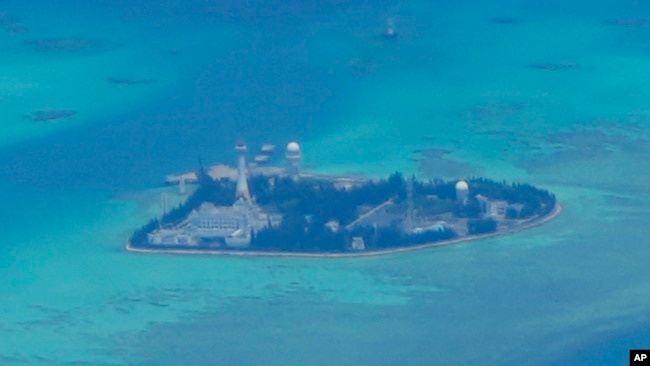 FILE - Chinese structures and buildings at the man-made island on Johnson South Reef at the Spratly Islands in the South China Sea are seen on March 20, 2022.