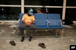 A homeless man sleeps at the Jorge Newbery international airport, commonly known as Aeroparque, in Buenos Aires, Argentina, April 6, 2023.