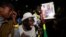 Supporters of Senegalese presidential candidate Bassirou Diomaye Faye celebrate early results showing that Faye is leading initial presidential election tallies, in Dakar, Senegal, March 24, 2024. 