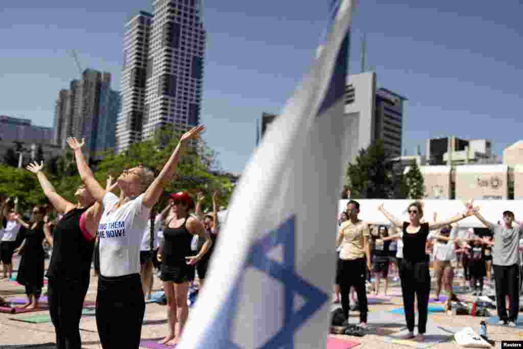 People practice yoga in a call for the release of yoga practitioner Carmel Gat among all other hostages kidnapped during the deadly October 7 attack by Palestinian Islamist group Hamas, in Tel Aviv, Israel.