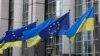 FILE - Flags of Ukraine fly in front of the EU Parliament building on the first anniversary of the Russian invasion, in Brussels, Belgium, Feb. 24, 2023. 