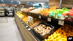 FILE - A man shops in a supermarket in Sydney on May 9, 2023. Food prices in Australia have increased by more than 7% in the past year.