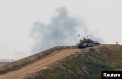 An Israeli tank conducts exercises near the Israel-Gaza border on March 14, 2024.