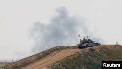 An Israeli tank maneuvers in Israel near the Israel-Gaza border, March 14, 2024. 