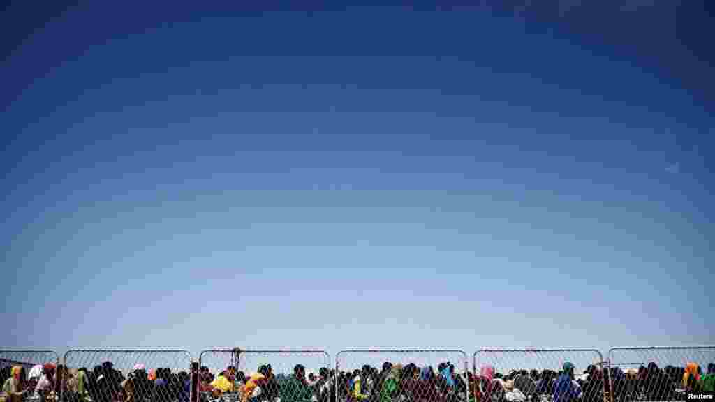 Migrants are seen on the deck of the military ship 'Cassiopea' to be transferred to the mainland, on the Sicilian island of Lampedusa, Italy, September 15, 2023. REUTERS/Yara Nardi 