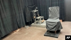 FILE - This undated photo provided by the South Carolina Department of Corrections shows the state's death chamber in Columbia, S.C., including the electric chair, right, and a firing squad chair, left. 