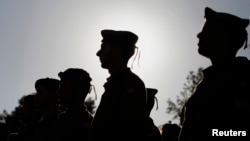 FILE - Israeli soldiers of the Netzah Yehuda infantry battalion stand at attention during their swearing-in ceremony in Jerusalem, May 26, 2013.