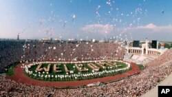 FILE - Some 1200 helium balloons are released into the air from the field of the Los Angeles Memorial Coliseum, July 28, 1984 as part of the opening ceremony for the XXIII Olympics.