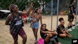 Relatives watch a football training session for young women run by the Bola de Ouro social program at the Complexo da Alemao favela in Rio de Janeiro, Brazil, May 16, 2024.
