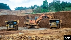 Excavators transfer soil to transport trucks at a nickel mine operated by nickel mining company Vale Indonesia in Sorowako, Indonesia, on July 28, 2023.