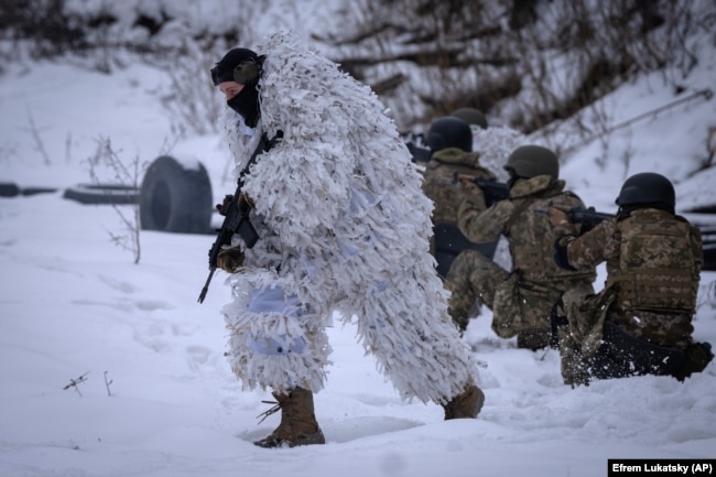 Members of the pro-Ukrainian Russian ethnic Siberian Battalion practice at a military training close to Kyiv, Ukraine, Wednesday, Dec. 13, 2023. (AP Photo/Efrem Lukatsky)