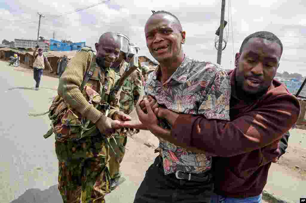 Police arrest a protester during clashes in the Mathare area of Nairobi, Kenya Wednesday, July 19, 2023. Kenyans were back protesting on the streets of the capital Wednesday against newly imposed taxes and the increased cost of living.&nbsp;