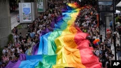 Participants hold a rainbow flag during the Pride Parade in Bangkok, Thailand, June 1, 2024.