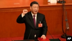 Chinese President Xi Jinping takes his oath after he is unanimously elected as President during a session of China's National People's Congress (NPC) at the Great Hall of the People in Beijing, March 10, 2023.