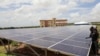 FILE - Engineers work on solar panels at the Benadir Electricity Company (BECO) solar project in Mogadishu, Somalia, May 21, 2020. 