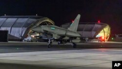 In this image provided on Jan. 12, 2024, by the UK Ministry of Defense, an RAF Typhoon aircraft returns to base at RAF Akrotiri in Cyprus, after striking targets in Yemen. 
