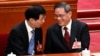 China's newly-elected Premier Li Qiang (R) is congratulated by Chinese People's Political Consultative Conference Chairman Wang Huning at the Great Hall of the People, March 11, 2023. (Greg Baker/Pool via Reuters) 
