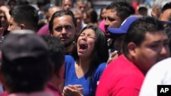 A relative of an 8-year-old girl who was kidnapped the previous day weeps as her body is handed over to family in Taxco, Mexico, March 28, 2024.