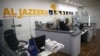 FILE - An employee of the Qatar-based news network and TV channel Al Jazeera is seen at the channel's Jerusalem office, July 31, 2017. 
