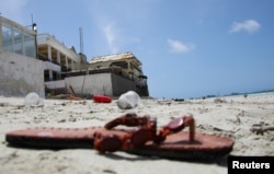 An abandoned shoe lies at the scene of an explosion that occurred while revelers were swimming at the Lido beach in Mogadishu, Somalia, Aug. 3, 2024.