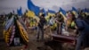 Cemetery workers bury the coffin of Oleksii Lytvynov, 29, during his funeral in Brovary, near Kyiv, Feb. 19, 2023. Lytvynov, a civilian who joined the Ukrainian Armed Forces, was killed on Feb. 11, during battle for Vuhledar in the southeast of the country.