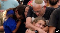 Family members mourn during the funeral of Israeli soldier Shilo Rauchberger at the Mount Herzl cemetery in Jerusalem, Oct. 12, 2023. 