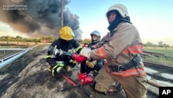 In this photo provided by the Ukrainian Emergency Service, rescuers work to extinguish a fire following a Russian attack in the Odesa region, Ukraine, Sept. 6, 2023.