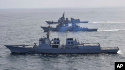 FILE - In this photo provided by South Korean Defense Ministry, destroyers from South Korea, bottom, the U.S., middle, and Japan sail during a joint missile defense drill in international waters off the east coast of the Korean Peninsula, April 17, 2023. 