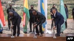 FILE - Akufo-Addo President of Ghana ( L), Paul Kagame (2nd L) president of Rwanda, Ugur Sahin CEO of BioNtech (R) break ground to mark the beginning of the construction of the first African mRNA vaccine factory in Kigali, Rwanda on June 23, 2022.