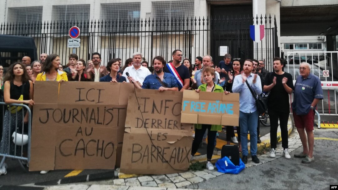 Protesters hold placards reading "Here, journalist in jail" and "Information behind bars" as they demonstrate in front of police headquarters in Marseille, France, Sept. 20, 2023, in support of jailed journalist Ariane Lavrilleux.