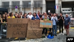Protesters hold placards reading "Here, journalist in jail" and "Information behind bars" as they demonstrate in front of police headquarters in Marseille, France, Sept. 20, 2023, in support of jailed journalist Ariane Lavrilleux.