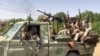 FILE - Fighters ride in the back of a pickup truck mounted with a turret in the East Nile district of greater Khartoum, in this image grab taken from handout video footage released by the Sudanese paramilitary Rapid Support Forces on April 23, 2023.