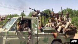 FILE - Fighters ride in the back of a pickup truck mounted with a turret in the East Nile district of greater Khartoum, in this image grab taken from handout video footage released by the Sudanese paramilitary Rapid Support Forces on April 23, 2023.