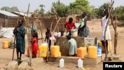 FILE - Sudanese refugees collect water from a borehole at the Gorom Refugee Camp hosting Sudanese refugees who fled fighting in their homeland, near Juba, South Sudan, Jan. 26, 2024. 