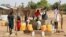 FILE - Sudanese refugees collect water from a borehole at the Gorom Refugee Camp hosting Sudanese refugees who fled fighting in their homeland, near Juba, South Sudan, Jan. 26, 2024. 