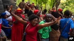 FILE - Believers dance during the St. George Vodou celebration in Port-au-Prince, Haiti, April 24, 2024.