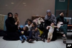 Palestinians take shelter in the Nasser hospital during Israeli bombardment in Khan Younis, Gaza Strip, Oct. 27, 2023.